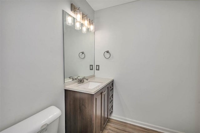 bathroom featuring vanity, toilet, and wood-type flooring