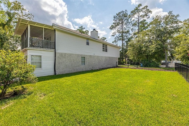 exterior space featuring a lawn and a sunroom