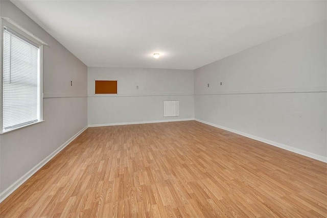 unfurnished room with light hardwood / wood-style flooring