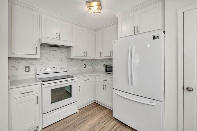 kitchen with light hardwood / wood-style floors, white cabinetry, white appliances, and tasteful backsplash