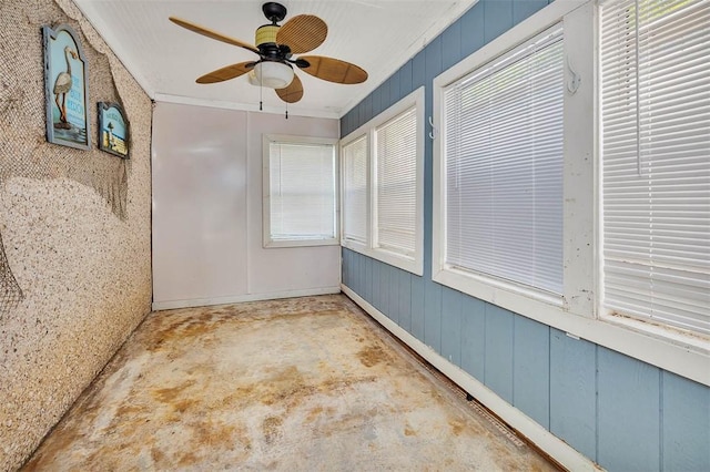 unfurnished sunroom with a wealth of natural light and ceiling fan