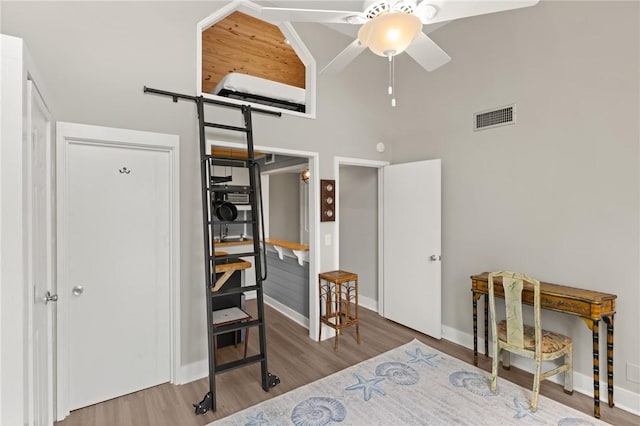 669 N Golf Villas, Saint Simons Island, GA 31522 - bedroom featuring a towering ceiling and wood finished floors