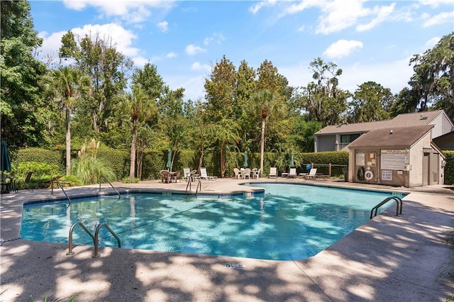 669 N Golf Villas, Saint Simons Island, GA 31522 - community pool with a patio area and view of wooded area