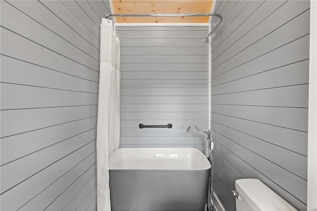 669 N Golf Villas, Saint Simons Island, GA 31522 - full bathroom featuring wooden walls and shower / bathtub combination with curtain
