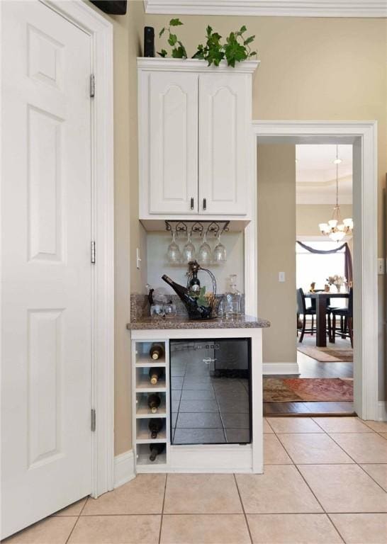 106 Hickory Pne, Brunswick, GA 31523 - indoor dry bar with wine cooler, a chandelier, light tile patterned floors, and baseboards