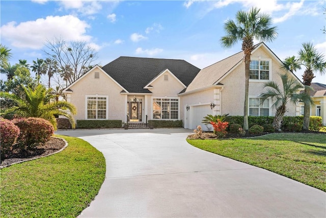 106 Hickory Pne, Brunswick, GA 31523 - traditional-style home featuring concrete driveway, a front yard, stucco siding, and a garage