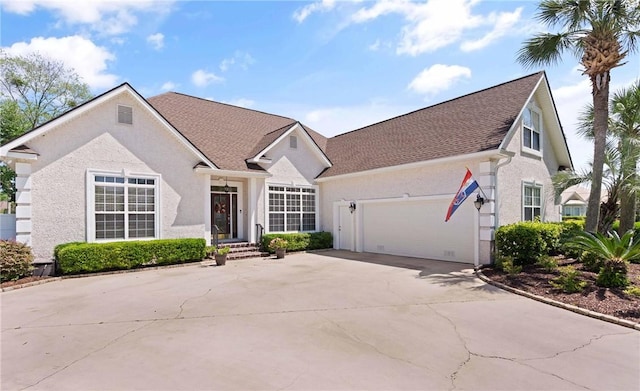 106 Hickory Pne, Brunswick, GA 31523 - view of front of home with a garage, driveway, stucco siding, and roof with shingles