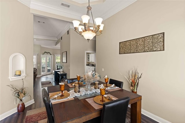 106 Hickory Pne, Brunswick, GA 31523 - dining space with a chandelier, ornamental molding, dark wood-type flooring, and baseboards