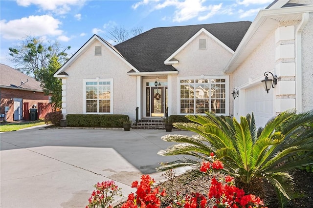106 Hickory Pne, Brunswick, GA 31523 - view of front of home with a garage, a shingled roof, and stucco siding