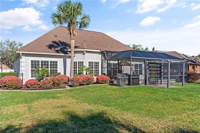 106 Hickory Pne, Brunswick, GA 31523 - back of house featuring a yard, glass enclosure, stucco siding, and a patio area