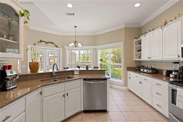 106 Hickory Pne, Brunswick, GA 31523 - kitchen featuring stainless steel appliances, a sink, dark stone counters, white cabinetry, and light tile patterned floors