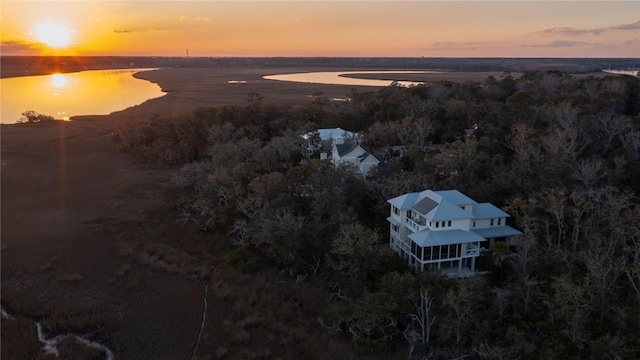 aerial view at dusk with a water view