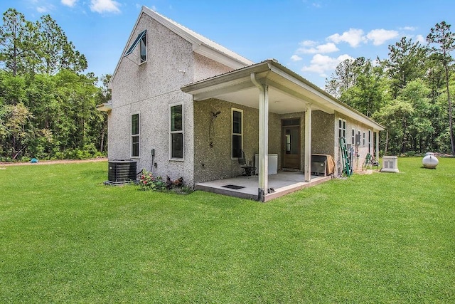1269 Sea Way, Townsend, GA 31331 - back of house with a patio, a yard, central air condition unit, and stucco siding