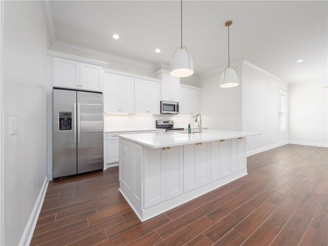 206 Placid Rd, Saint Marys, GA 31558 - kitchen featuring appliances with stainless steel finishes, decorative backsplash, dark wood-type flooring, ornamental molding, and white cabinetry