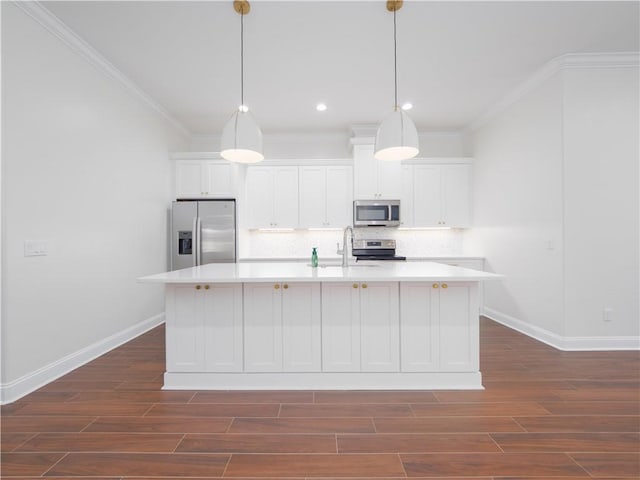 206 Placid Rd, Saint Marys, GA 31558 - kitchen with appliances with stainless steel finishes, a center island with sink, backsplash, light countertops, and ornamental molding