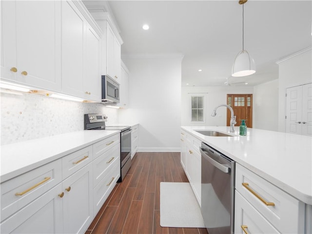 206 Placid Rd, Saint Marys, GA 31558 - kitchen with stainless steel appliances, white cabinetry, dark wood-style flooring, light countertops, and recessed lighting