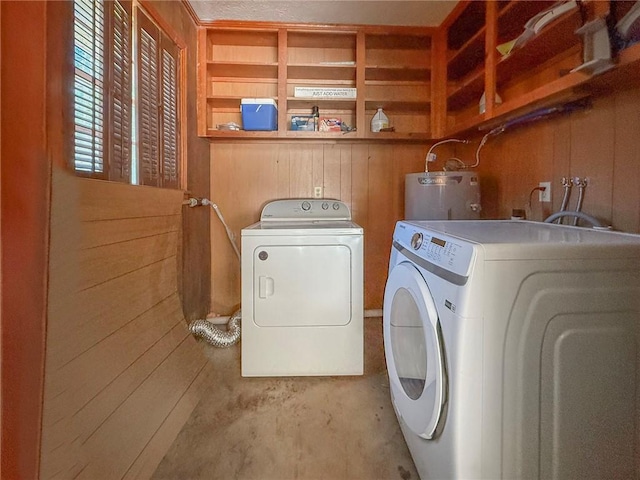 706 Jenkins St, Blackshear, GA 31516 - laundry room with water heater, washing machine and dryer, and wood walls