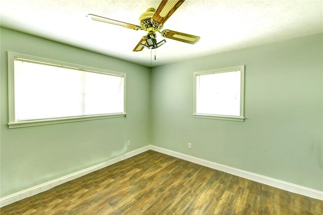706 Jenkins St, Blackshear, GA 31516 - unfurnished room with dark wood-type flooring, a ceiling fan, and healthy amount of natural light