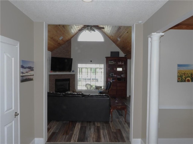 105 Lonnie Johnson Rd, Hazlehurst, GA 31539 - living area featuring ceiling fan, wood finished floors, ornate columns, a fireplace, and lofted ceiling