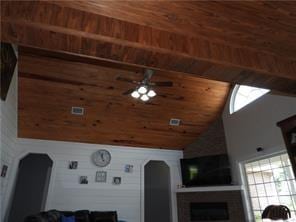 105 Lonnie Johnson Rd, Hazlehurst, GA 31539 - living area with wooden ceiling, arched walkways, ceiling fan, a fireplace, and plenty of natural light