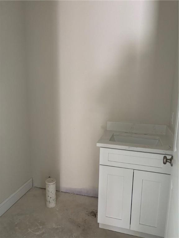 bathroom featuring concrete flooring and vanity