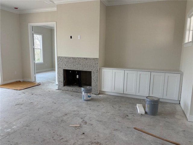 unfurnished living room with crown molding