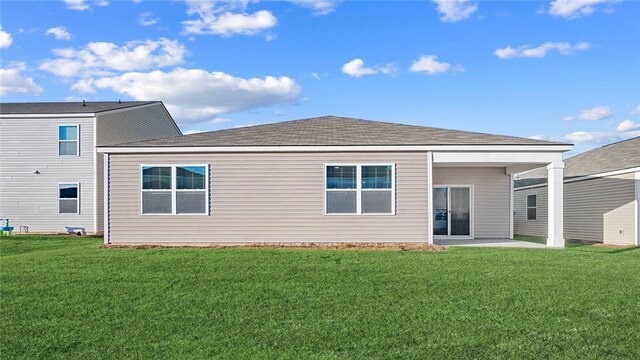 1037 Lakes Blvd, Brunswick, GA 31525 - rear view of house with a yard and a patio area