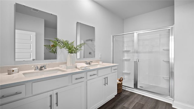 1037 Lakes Blvd, Brunswick, GA 31525 - bathroom featuring double vanity, a shower stall, and wood finished floors