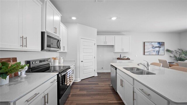 1037 Lakes Blvd, Brunswick, GA 31525 - kitchen featuring appliances with stainless steel finishes, dark wood-style flooring, recessed lighting, white cabinets, and light countertops