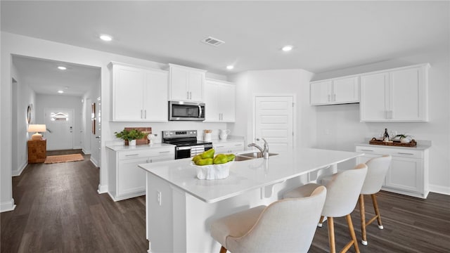 1037 Lakes Blvd, Brunswick, GA 31525 - kitchen with appliances with stainless steel finishes, dark wood finished floors, white cabinetry, light countertops, and recessed lighting