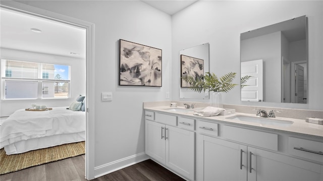 1037 Lakes Blvd, Brunswick, GA 31525 - ensuite bathroom with double vanity and wood finished floors