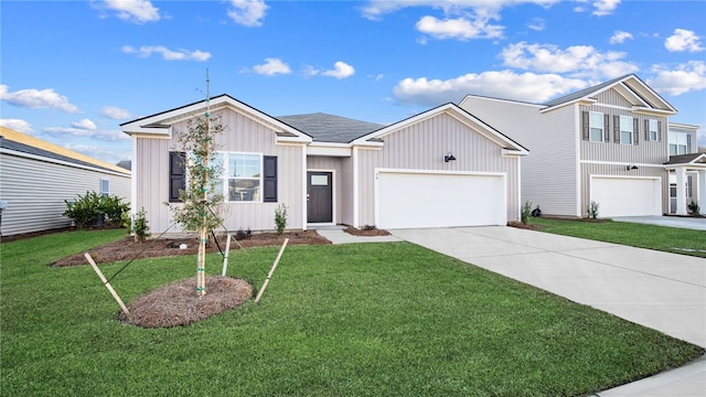 1037 Lakes Blvd, Brunswick, GA 31525 - view of front of house featuring concrete driveway, board and batten siding, a front lawn, and a garage