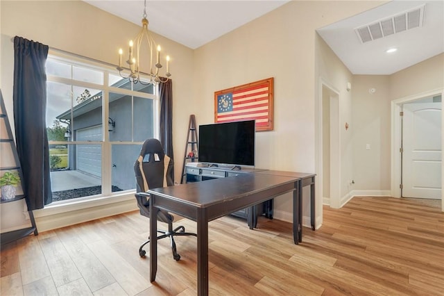 office area featuring light wood-type flooring and an inviting chandelier