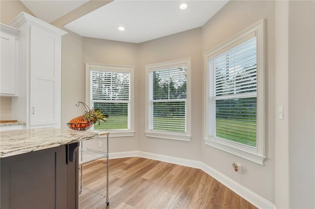 unfurnished dining area featuring light wood-type flooring