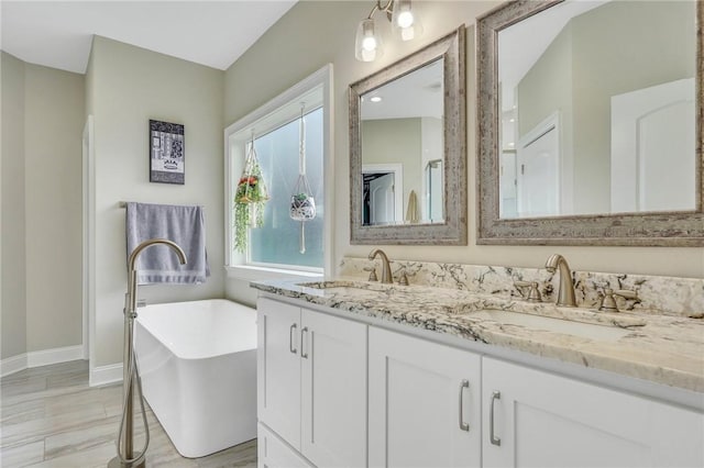 bathroom with vanity and a bath