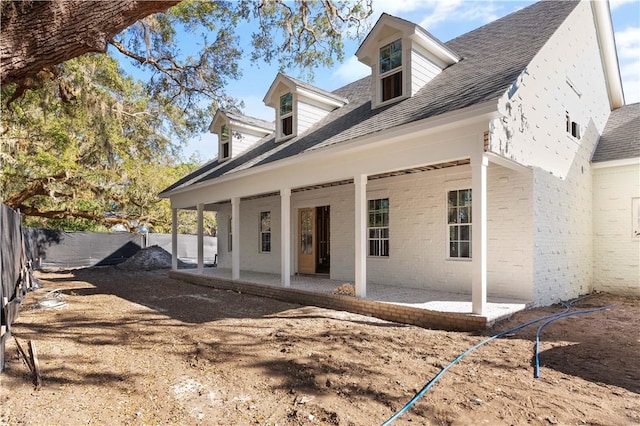 rear view of property featuring a patio area