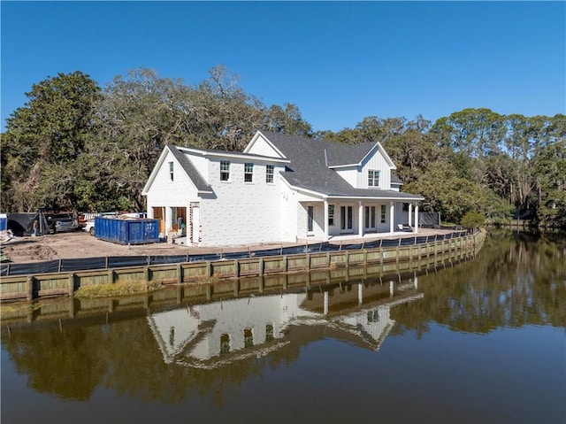 back of house featuring a water view