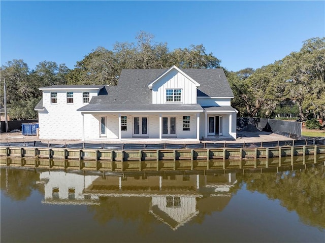 back of property with a water view