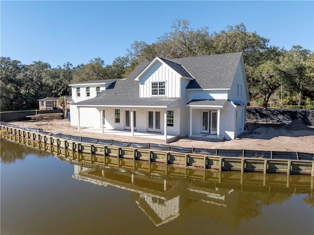 rear view of property with a water view