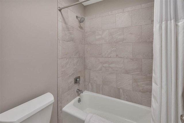 bathroom with shower / tub combo and toilet