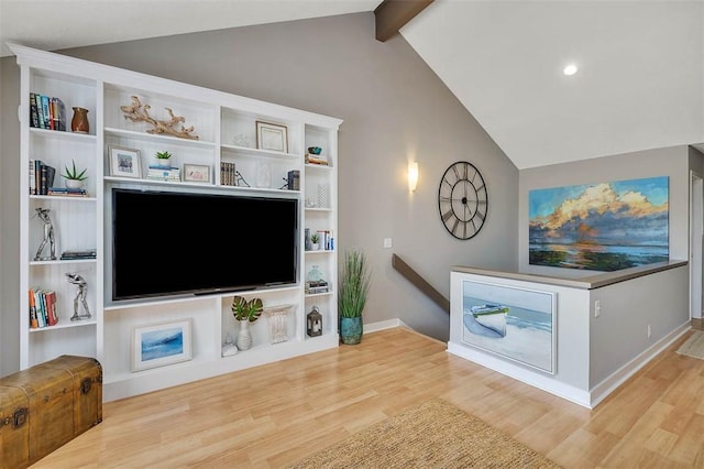 living room with lofted ceiling with beams and light hardwood / wood-style floors