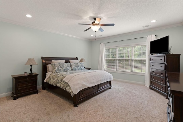 carpeted bedroom featuring a textured ceiling, ceiling fan, and crown molding