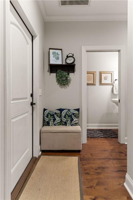 hallway featuring dark hardwood / wood-style flooring and ornamental molding