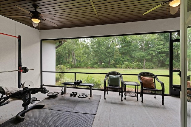 sunroom / solarium featuring ceiling fan