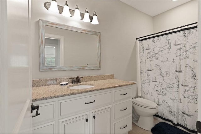 bathroom featuring a shower with curtain, vanity, toilet, and tile patterned floors