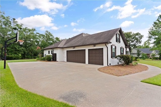 view of property exterior with a yard and a garage