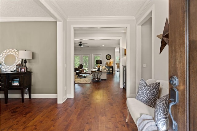 interior space with a textured ceiling, dark hardwood / wood-style floors, ceiling fan, and crown molding