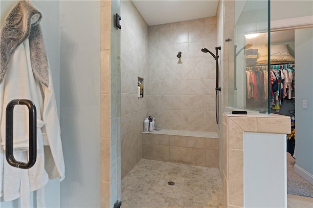 bathroom with a shower with door