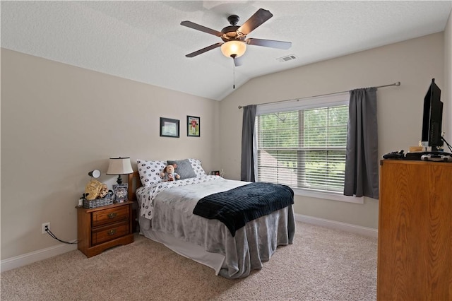 bedroom featuring a textured ceiling, ceiling fan, light carpet, and vaulted ceiling