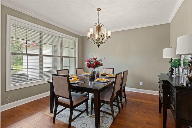 dining space with hardwood / wood-style floors, a textured ceiling, crown molding, and a chandelier